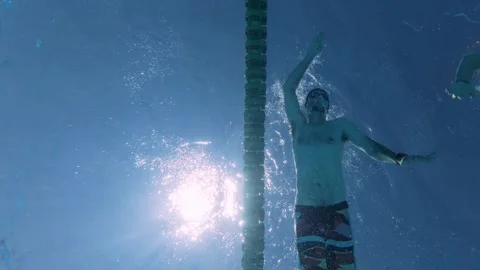 Low Angle View of Man Swimming Front Crawl in Sunny Pool 스톡 동영상 342015632