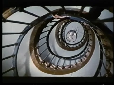 Low angle view of man walking up spiral staircase Stock Footage 260247648
