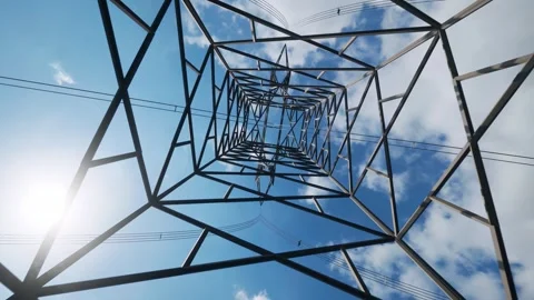 Low Angle View of Massive Metal Transmission Tower Against Blue Sky Video stock 339079619