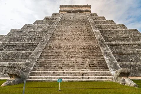 Low angle view of the massive stone staircase and serpent head sculptures at the Photos