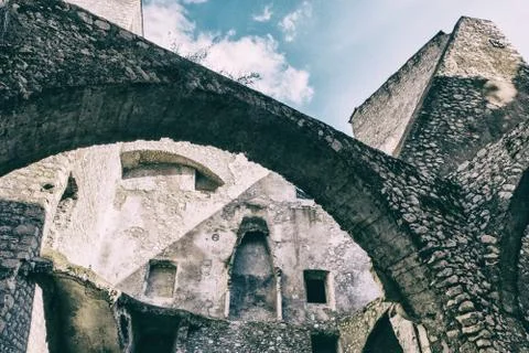 Low angle view of a medieval stone worn wall castle with blue sky background. 스톡 사진