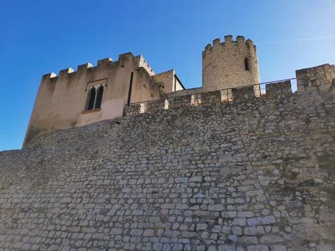 Low angle view of the medieval stone walls and tower of Castellet Castle. Stock Photos