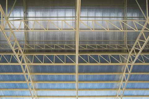 Low angle view of metal building roof structure with heat insulations insid.. Stock Photos