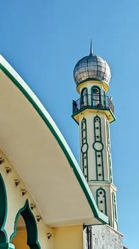 Low angle view. A minaret of the mosque under a clear blue sky Stock Photos