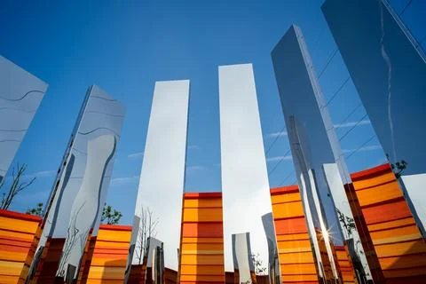 Low angle view of mirrored pillars against blue sky - Future concept Stock Photos