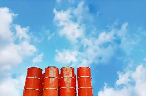 Low Angle View of Mixed Concrete Tanks Against Blue Cloudy Sky Stock Photos