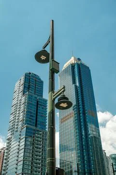 Low angle view of modern blue glass skyscrapers and a street lamp against a Foto stock
