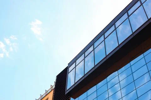 Low angle view of modern building with tinted windows against blue sky Fotos de archivo
