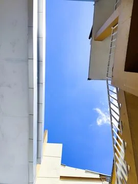 Low Angle View of Modern Building Architecture Under a Clear Blue Sky with Minim Stock Photos