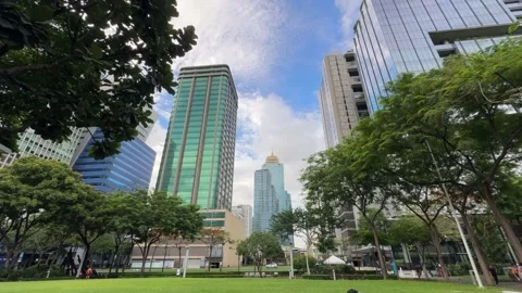 Low angle view of modern glass skyscrapers at BGC Taguig in 4K 스톡 동영상 337950730
