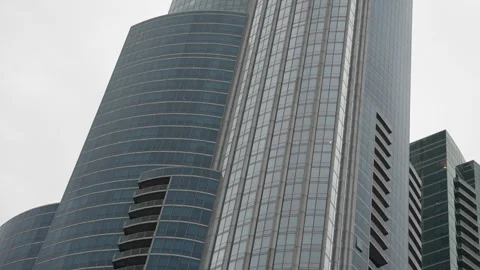 Low angle view of modern glass skyscrapers against sky Vídeo Stock 340834436