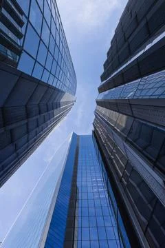 Low angle view of modern glass skyscrapers reaching into the sky Stock Photos