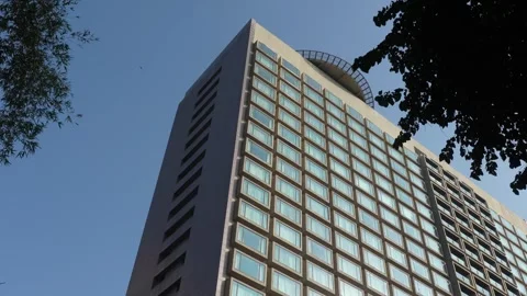 Low Angle View of Modern High Rise Building Against Clear Blue Sky Stock Footage 323500655