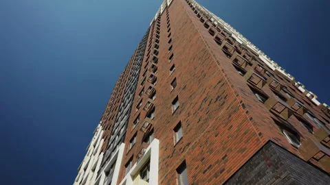 Low angle view of modern high rise residential building with brick facade 動画素材 347214471