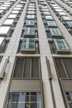 Low angle view of modern high-rise building facade Stock Photos