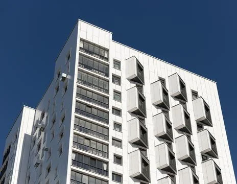 Low angle view of modern high rise residential building top corner with pro.. Stock Photos