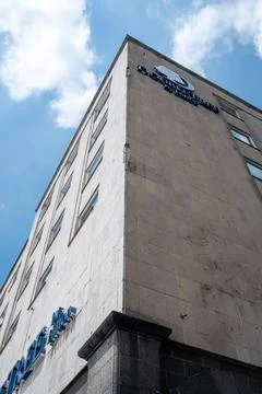 Low angle view of a modern hotel facade rising against a bright blue sky Stock Photos
