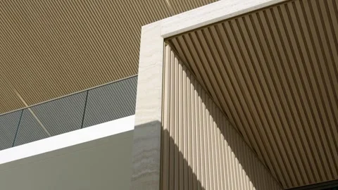 Low angle view of modern house exterior with wooden fluted panels and glass Stock Footage 242943822