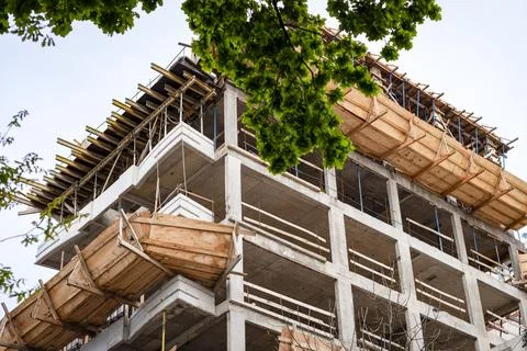 Low angle view of modern multistory building construction site with concret.. 스톡 사진