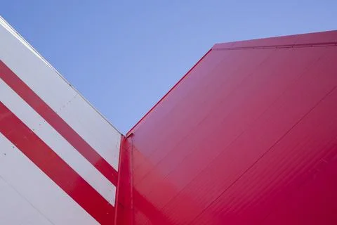 Low Angle View Of  Modern Office Building with Red Facade against blue sky Stock Photos