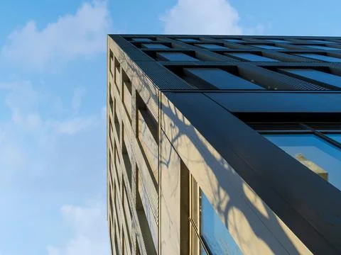 Low angle view of a modern office building corner with metal facade and win.. Stock Photos