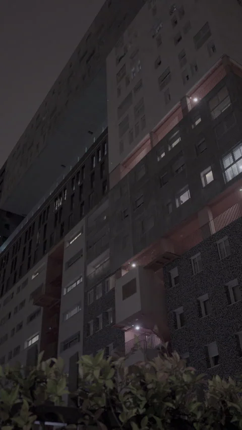 Low angle view of modern residential building at night 스톡 동영상 320539646