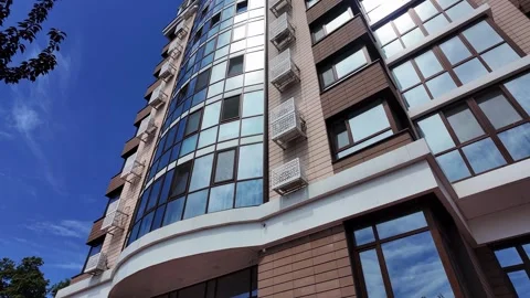 Low angle view of a modern residential building facade on a clear sunny day. Video stock 336948813