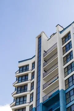Low angle view of modern residential architecture with blue and white facad.. Stock Photos