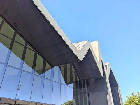 Low angle view of the modern Riverside Museums iconic jagged roof against a Stock Photos