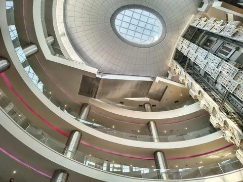 Low angle view of modern shopping mall atrium with circular skylight Stock Photos