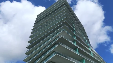 Low angle view of modern skyscraper with many floors and unique angular design Stock Footage 258454325