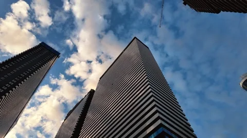 Low angle view of modern skyscraper architecture under blue sky 스톡 동영상 335143072