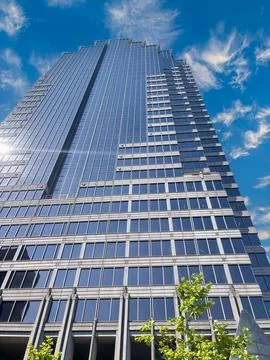Low-angle view of a modern skyscraper with reflective glass panels. Stock Photos