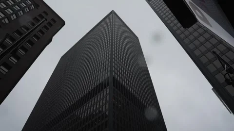 Low-angle view of modern skyscrapers against an overcast sky Video stock 346848847