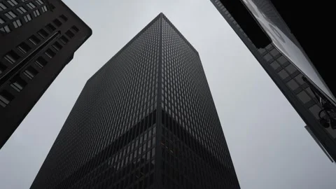 Low-angle view of modern skyscrapers against an overcast sky Video stock 346848848