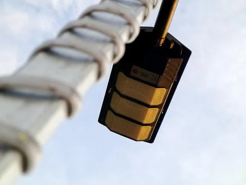 Low Angle View of a Modern Street Light with Gold Panels Stock Photos