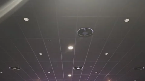 Low angle view of a modern suspended ceiling with square tiles, integrated air Stock Footage 346539371
