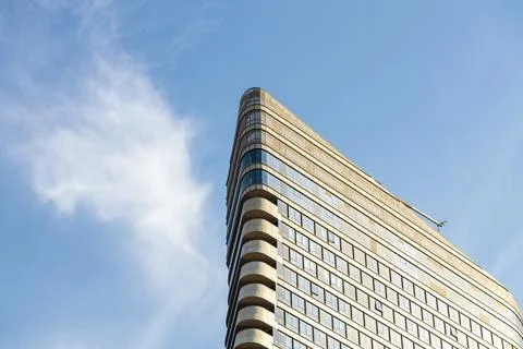 Low angle view of modern triangular corporate building corner  Fotos Stock