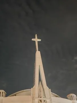 Low Angle View of Modern White Church Spire and Cross Against Night Sky Stock Photos
