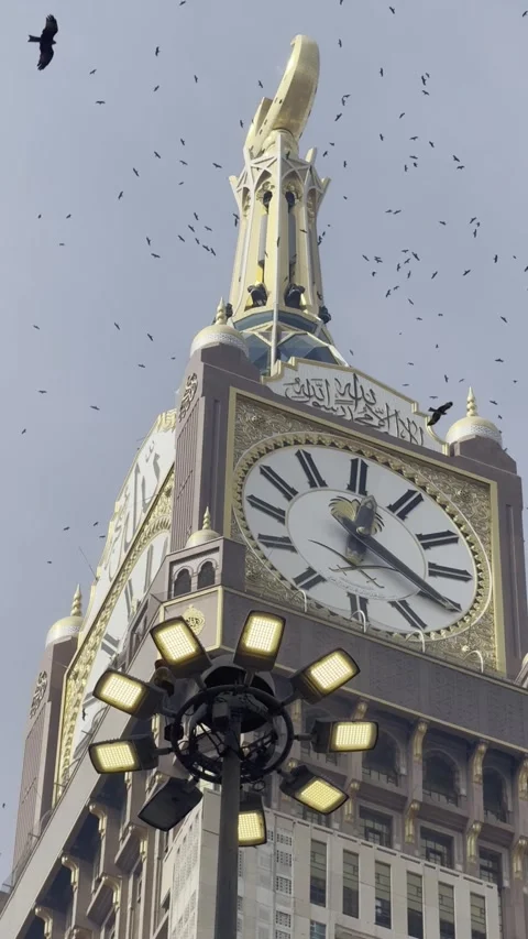 Low angle view of a monumental clock tower near the Grand Mosque in Mecca, Saudi Stock Footage 323157092