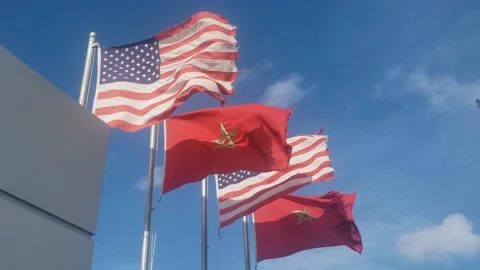 Low angle view of  Moroccan and USA flags waving - USA and Morocco friendship Stock Footage 151116136