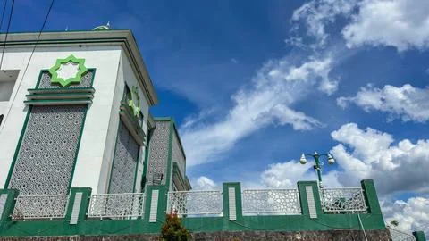 Low angle view of a Mosque exterior featuring green and white colors, intrica Stock Photos