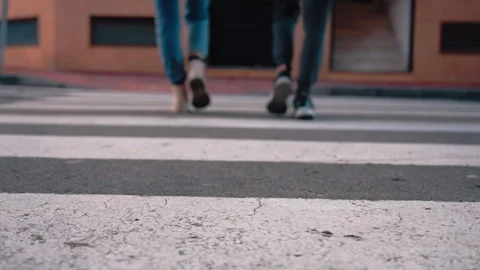 Low angle view of mother and young son legs cross city zebra crossing, boot.. Stock Footage 327227480