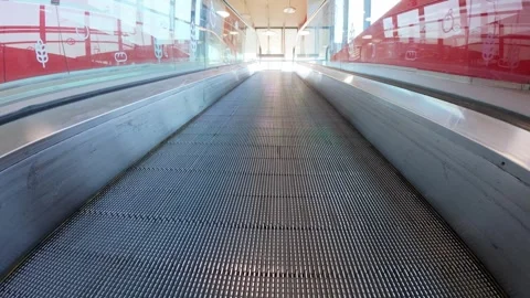 Low-angle view moving up an escalator ramp in a shopping mall. Modern indoor Stock Footage 311153908