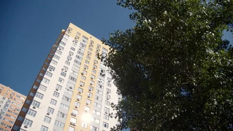 Low angle view of a multi storey building on blue sky background. Stock Footage 255226634