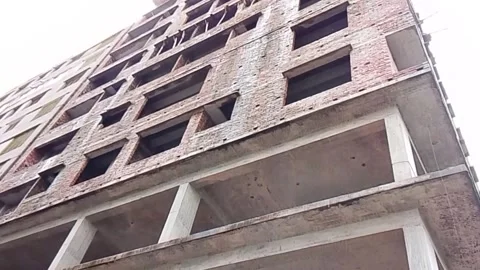 Low angle view of multi-story brick apartment building under construction Vídeo Stock 342169510