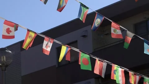 Low angle view of national flag banner strings hanging in city street Video stock 324944302