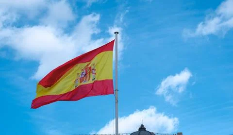 Low angle view of the national flag of Spain waving proudly in the wind again Stock Photos