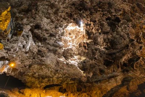 Low angle view of natural cave ceiling with sunlight penetrating through it. Stock Photos