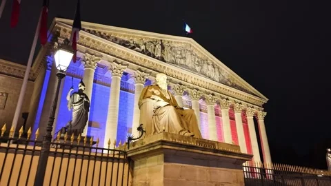 Low-angle view of the neoclassical National Assembly parliament facade glowing Vídeo Stock 323984360